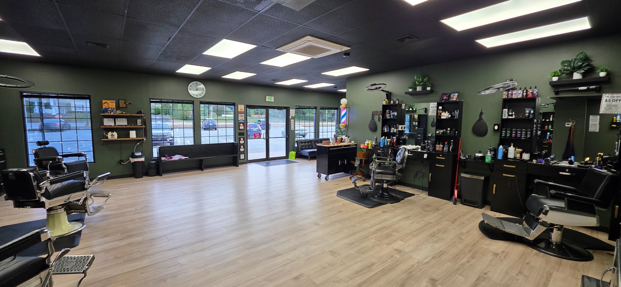 The current Chop Shop interior with barber chairs, stations, and front windows
