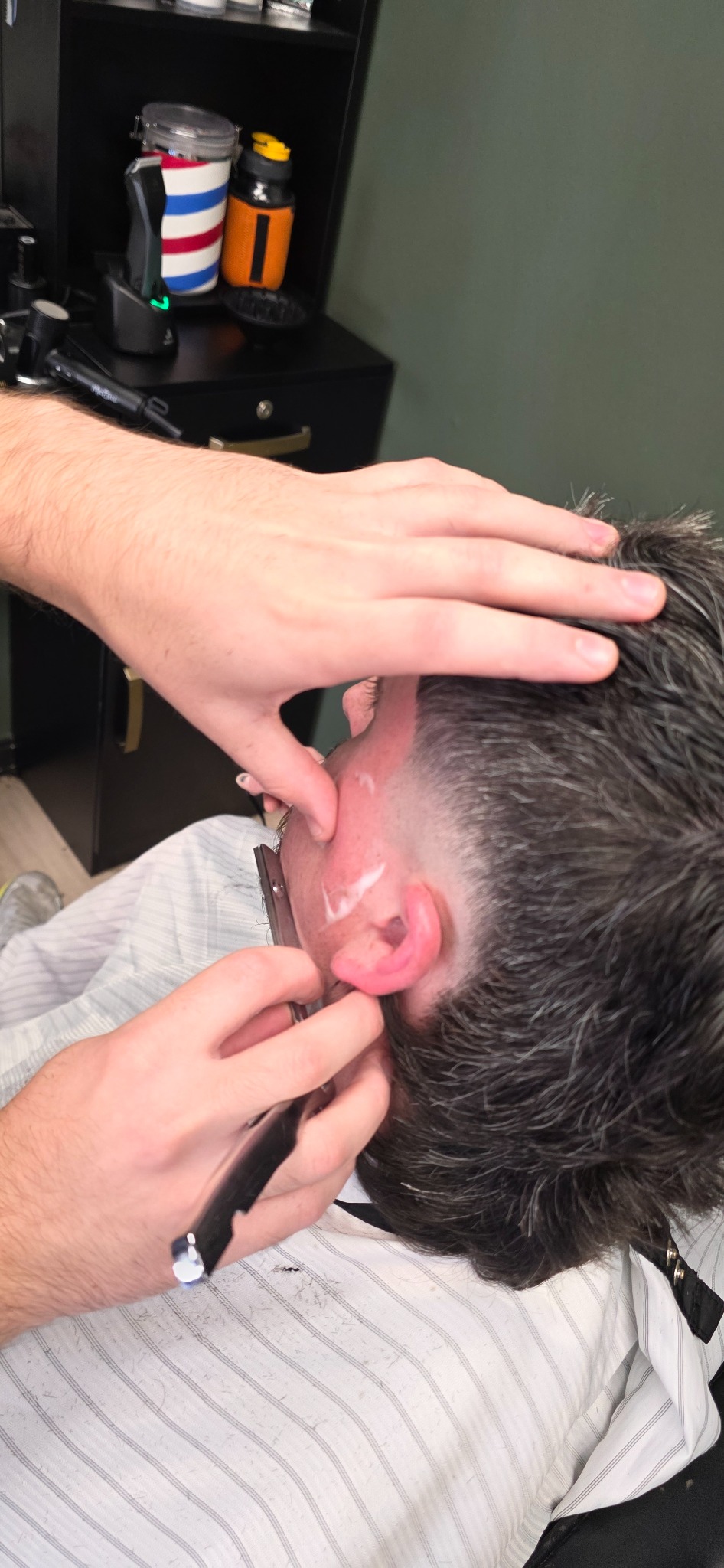 Close-up straight-razor detail work at The Chop Shop